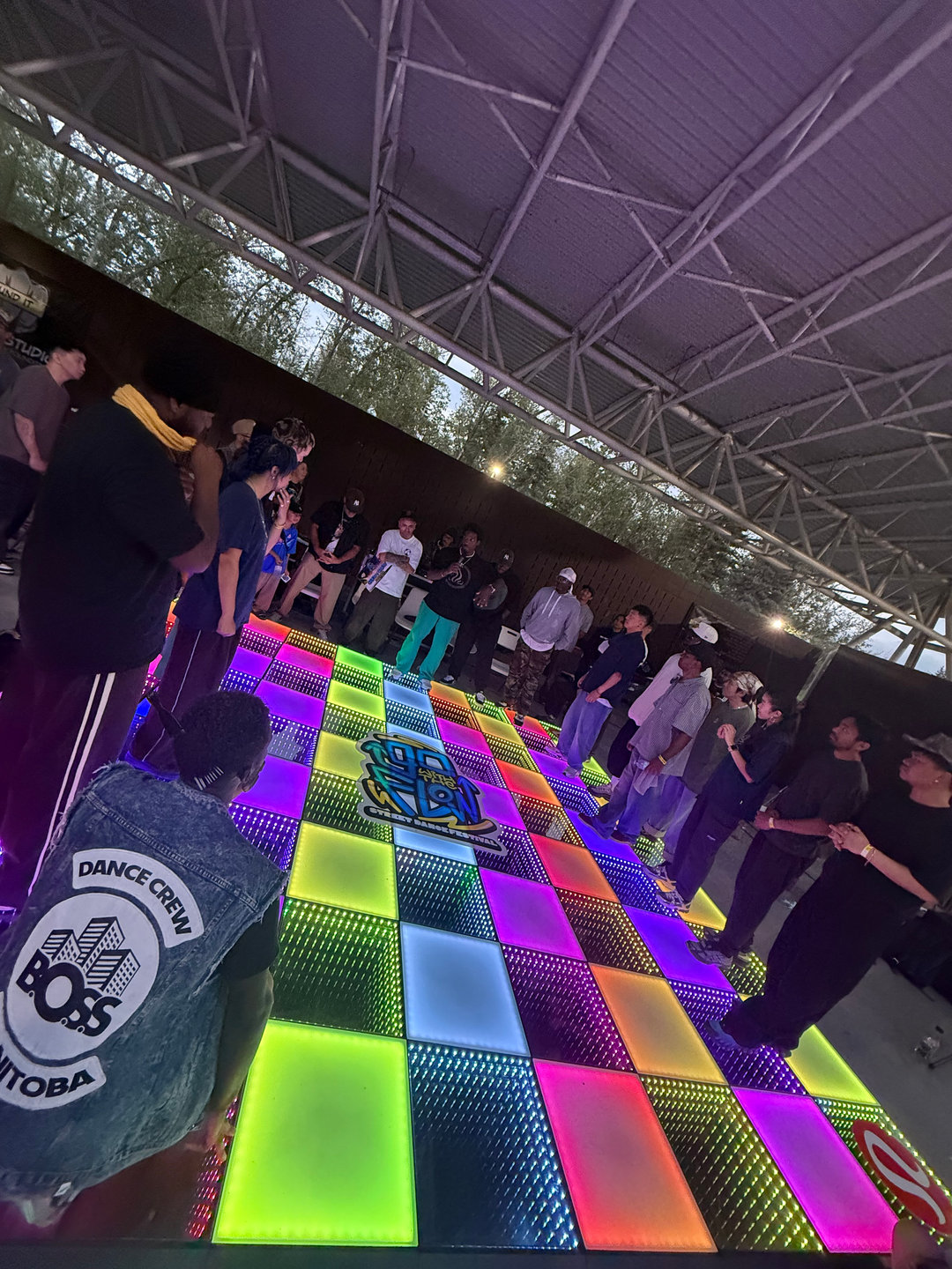 The community gathered around a colourful outdoor dance floor